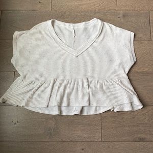 White blouse with multicolored detail.